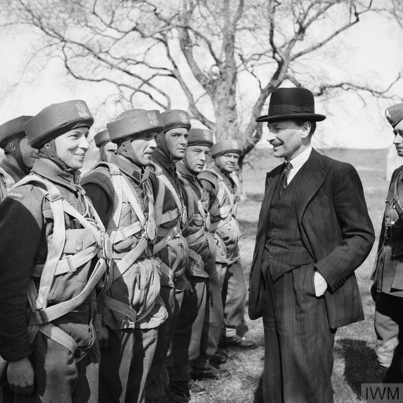 THE POLISH ARMY IN BRITAIN, 1940-1947 (H 18882) Clement Attlee visiting troops of the 1st Polish Independent Parachute Brigade at Cupar, 20 April 1942. Note their headwear - paratrooper's training helmets also known as 'bungee helmets'. Copyright: © IWM. Original Source: http://www.iwm.org.uk/collections/item/object/205194899